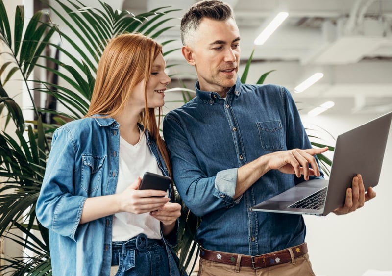 man-showing-something-laptop-his-coworker (1)